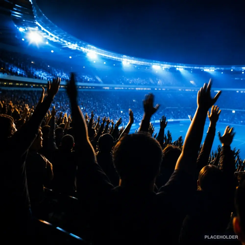 Sports fans celebrating under stadium floodlights at night